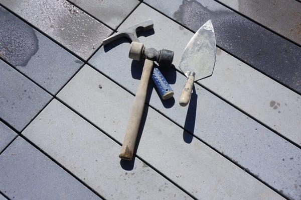 mason tools for laying pavers.