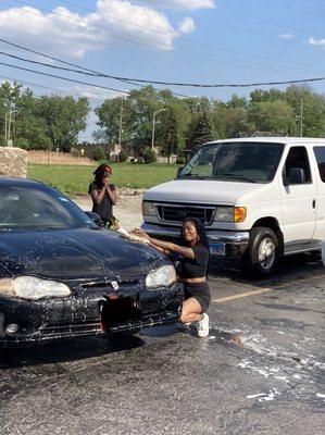 Employees washing cars outside