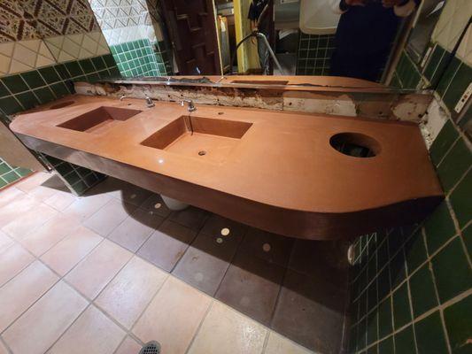 Bathroom countertop with integral terracota concrete color.

Polished and sealed.