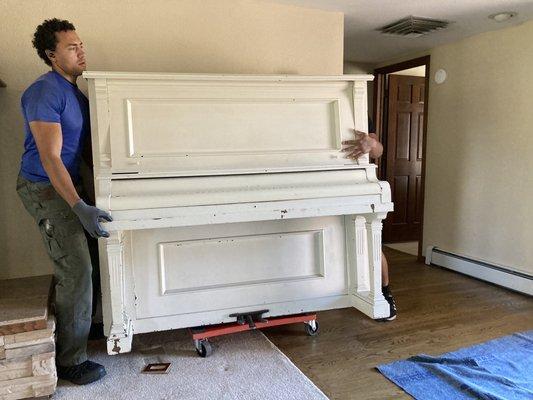 The two JOG movers preparing the piano for moving.