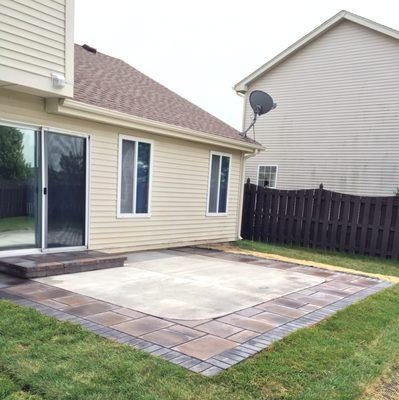 After patio installation, wet concrete patio with pavers. Looks much better than the rotted deck!