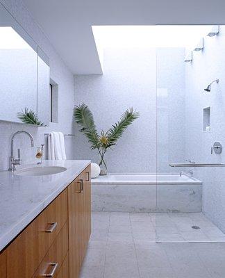 Natural stone and teak wood create a peaceful refuge in the master bath