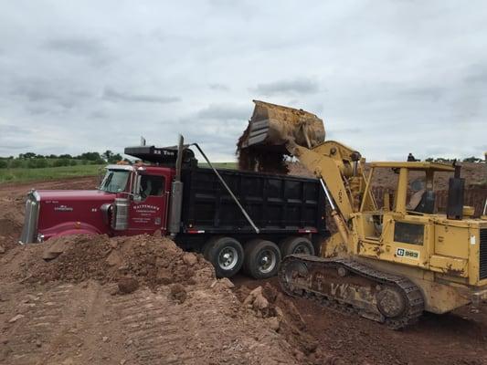 Digging for a 10'x65' manure storage tank.