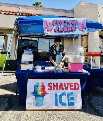 This is a glimpse of what our setup looks like at Frozen Paradise! Here, I'm under our vibrant tent, crafting a delicious shaved ice treat.