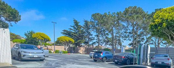 Regulars wait for an available charger by queuing alongside the dumpster (on the left where grey VW is parked).