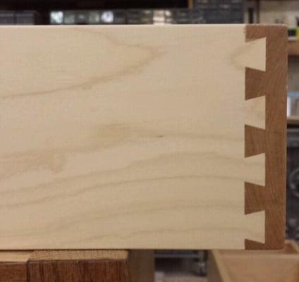 Typical drawer box with dovetailing - notice the color contrast between the light and dark maple.