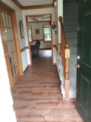 Natural oak hardwood  look performed with a laminate flooring been installed. To fix your floor Coastal Floors Renovations is here!