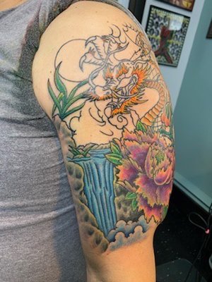 Session 2 of 4. New tattoo to cover an old stock dragon tattoo I got when young and dumb (it's under the flower and body of new dragon).