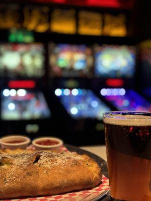 An Lunar Eclipse Calzone (from Moon Pizza Pie) being enjoyed with a ice cold Yuengling at Satellite Pinball Lounge