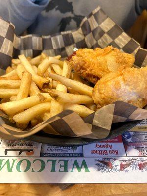 Two piece dark chicken basket with fries and coleslaw on the side.