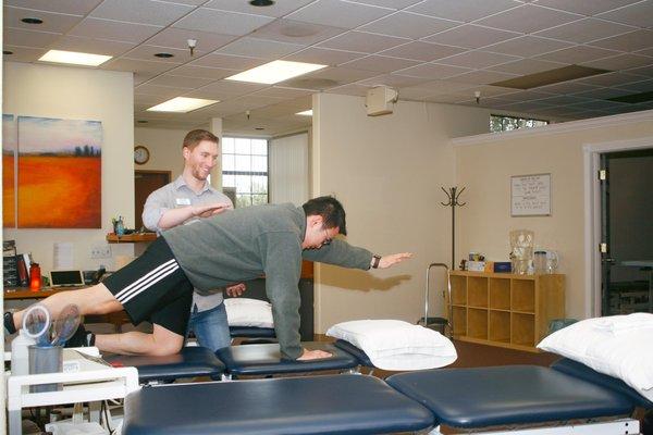 Physical Therapist, Dr. Ian Gilkison works with an aide on his Bird-Dog form. Photo by: Jennifer Twist