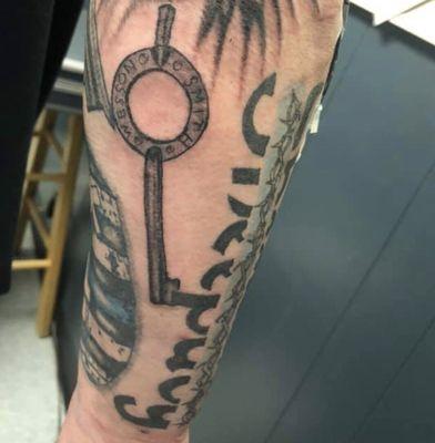 My Smith and Wesson handcuff key and part of the sheep dog tattoo . Artwork by Kevin Graf of Goathead Graffix tattoo.