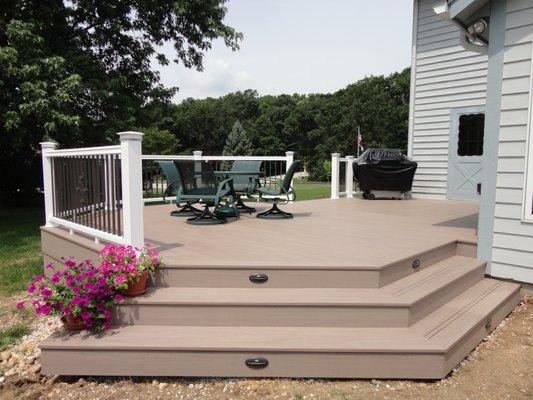 Azek PVC Composite Deck with wide/open step concept. LED Accent Step Lighting. Timbertech Composite Handrails with Lighted Caps