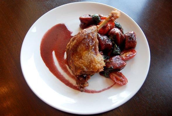 Confit Duck Leg served with beet gnocchi and spinach with a plum duck demi