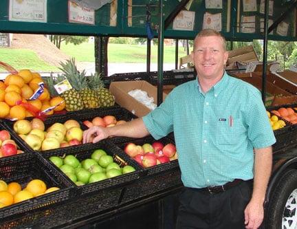 Stacey at work at traveling produce stand. In business 20 years.