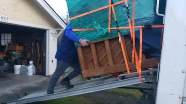 That's Tony "The Bull" putting the brakes on a 750lb Upright Grand Piano. Shoes by Columbia. Tread and traction? Amazing!