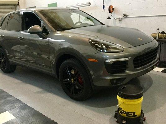 Porsche Cayanne with a Xpel clear bra and matte black hood accent, blacked out wheels and red caliper paint all done in house.