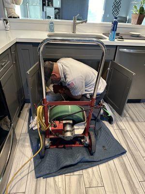 Technician Jack clearing a kitchen sink stoppage