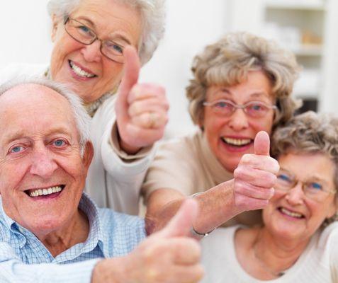 Group of happy seniors smiles & thumbs up