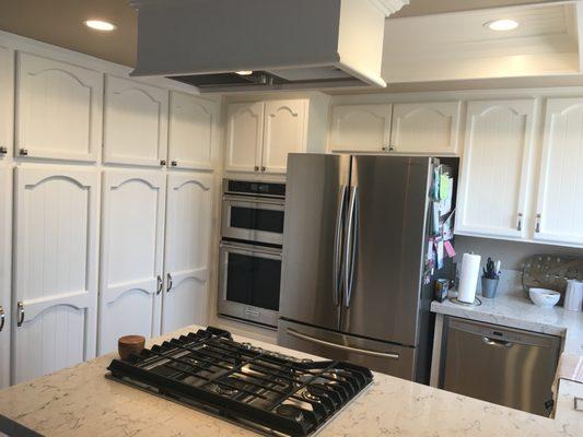 New counters, appliances, lighting, custom vent, and revarnished/painted cabinets.