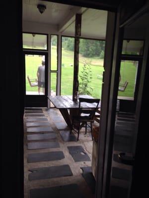 Screened in area with rustic table.