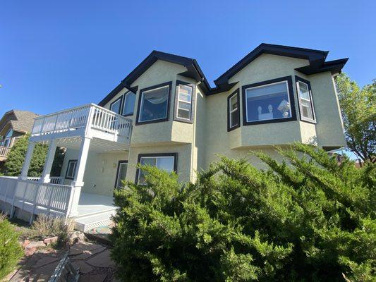 Exterior home painting over stucco and deck staining.