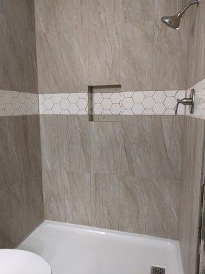 Tile shower with custom inset feature tile