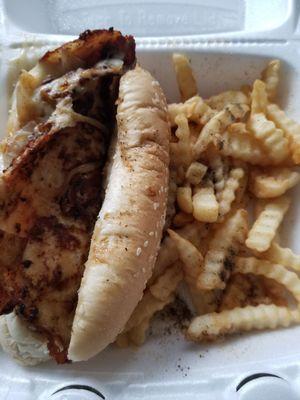 Chicken philly sandwich with fries.