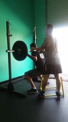 Mitch helping out our client Mike with his box squat.