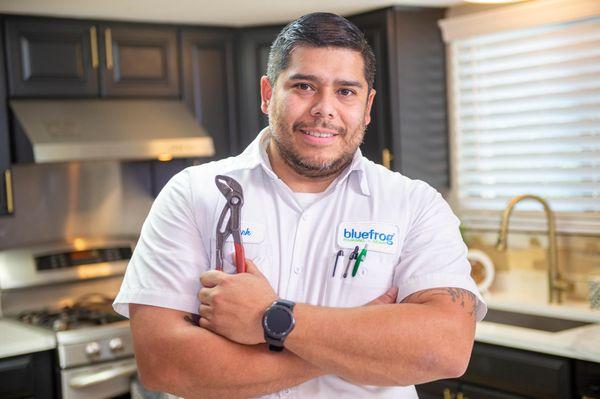 Plumber holding a tool working on drain service in the Dallas Carrollton area.