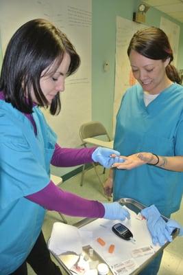 Students practicing Clinical Medical Assisting skills