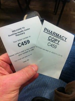 The pharmacy gives you TWO print outs when you check in. Take both, then have a seat and wait for your number to be called.