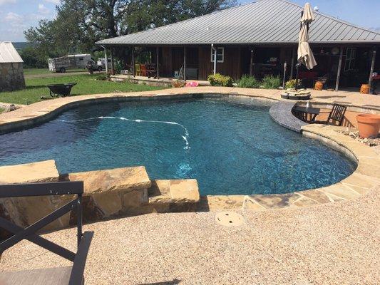 Custom Pool with swim up bar and also has a spa.