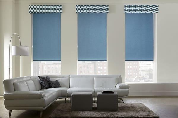 The geometric print selected for these fabric cornices is a great touch to these bold peacock blue Roller Shades.