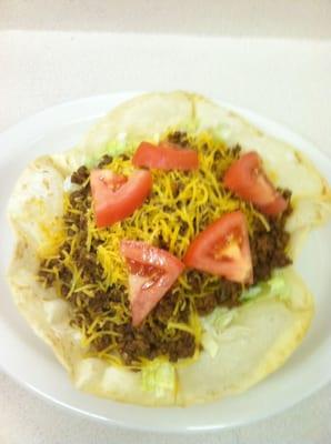 Whole Taco Salad:  Served in a crisp flour tortilla with shredded lettuce, taco meat, cheese, tomatoes, & your choice of dressing.