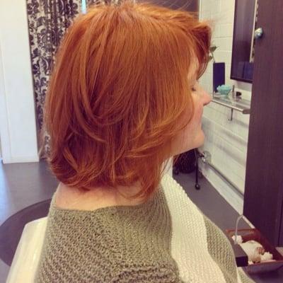 A beautiful natural looking red hair color with a versatile cut