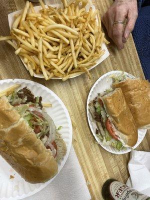 Classic Rudy's cheese steaks and french fries.