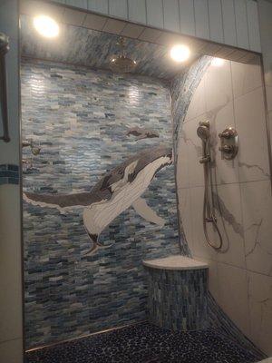 This shower was made to appear as though a wave is going overhead. Over 65 square foot of Mosaic glass was installed in this bathroom.