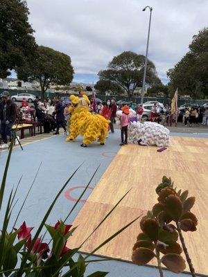 Lion dancing, leaping, jumping & stunts, mixing with the audience, and throwing candy!