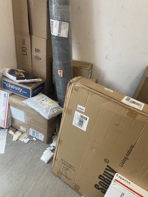 Garbage and people's packages stuffed into a corner.