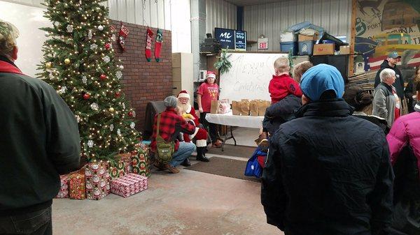 Santa listening to wishes at 2017 Children's Christmas Party.