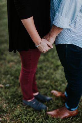 Photo of a couple holding hands.