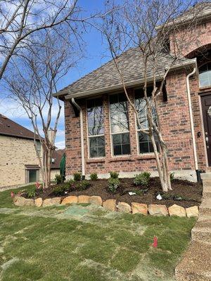 New bed design with down spouts directed underground and out of flower beds to prevent erosion in the beds. Laid fresh Tiftuf Bermuda.