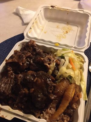 Yum  Oxtails ,cabbage planta and rice and beans