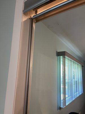 You can see the frame is falling off from glass door.