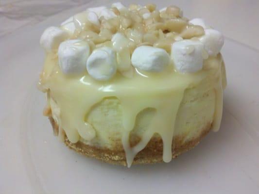 vanilla cheesecake, macadamia nut crust, smothered in white chocolate ganache, crowned with marshmallows and macadamia nuts.