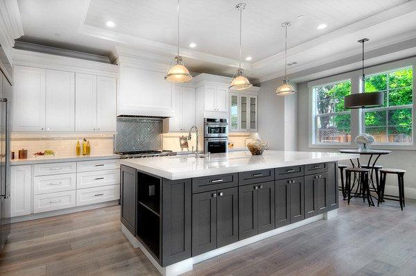 European Oak Flooring, dark grey island and White kitchen cabinets