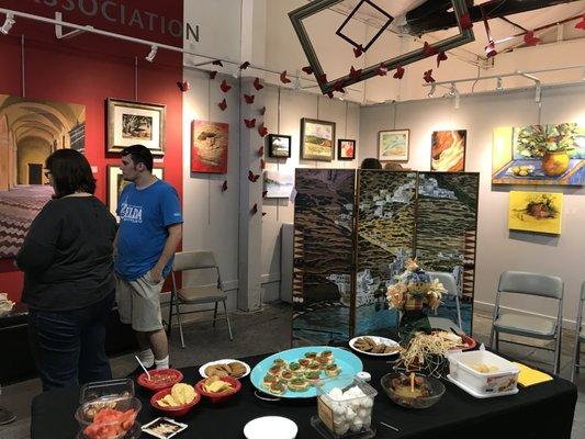 Photographers Becky and Chris Silva take in the work at an Art After Dark reception.