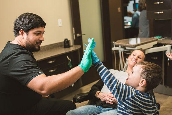 Dr Walia High-fiving a young patient!