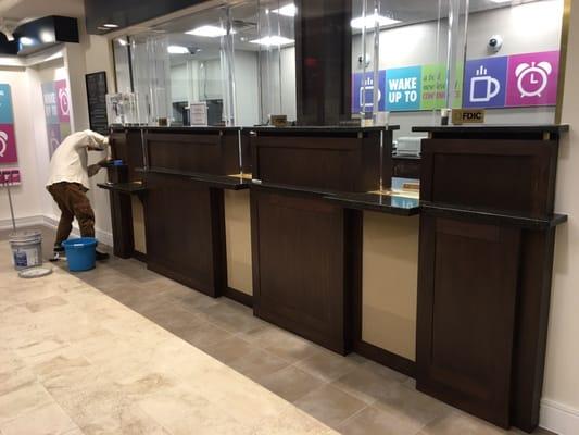 Bank teller line manufactured from solid walnut and walnut veneers.